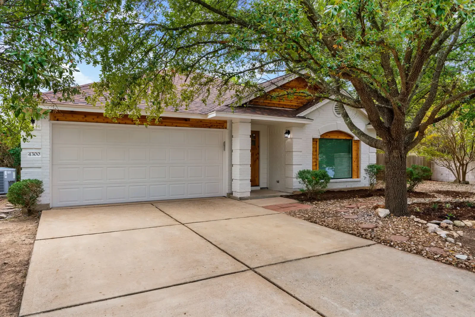 Contemporary Austin home exterior after a full remodel with new roof, windows and paint &mdash; Bremner project by Bailey & Bear Construction