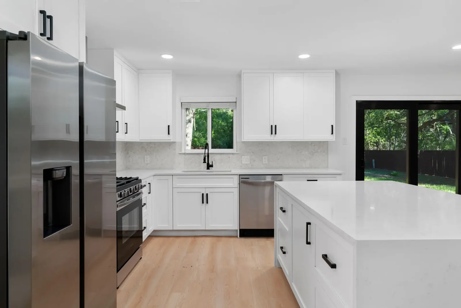 Remodeled Austin kitchen with two parallel work runs, full-height shaker cabinets and a clear centre walkway, built by Bailey & Bear Construction on the Emerald Forest full remodel