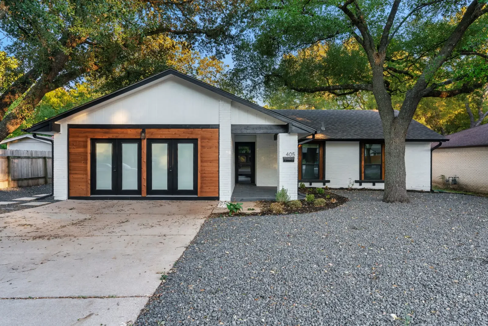 Exterior of a classic Austin home after a full renovation including new roof, windows, doors and exterior paint &mdash; Emerald Forest project by Bailey & Bear Construction